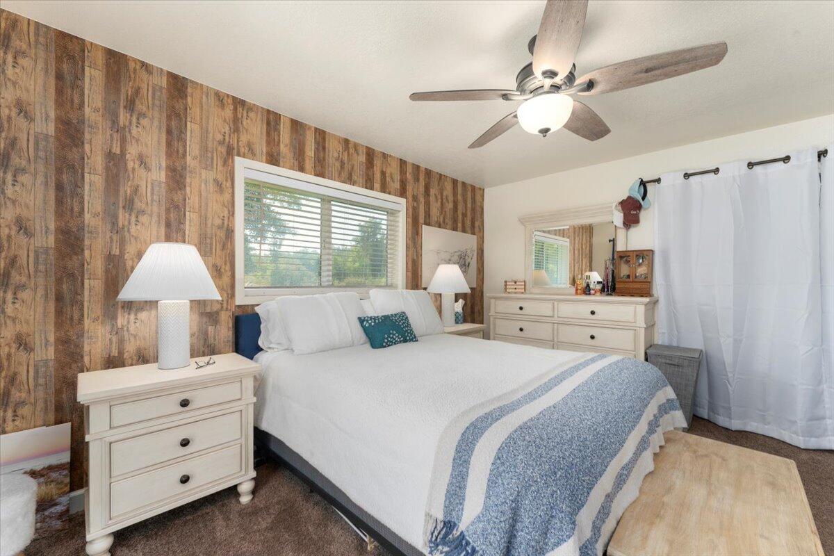 12325 Craig Avenue Red Bluff, CA 96080 - Photo 24 of 68 a bedroom with a bed and a chandelier