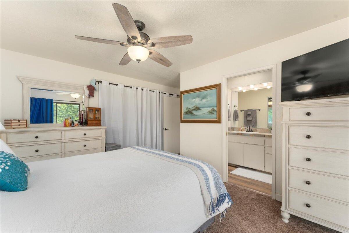12325 Craig Avenue Red Bluff, CA 96080 - Photo 25 of 68 a spacious bedroom with a large bed and a flat screen tv