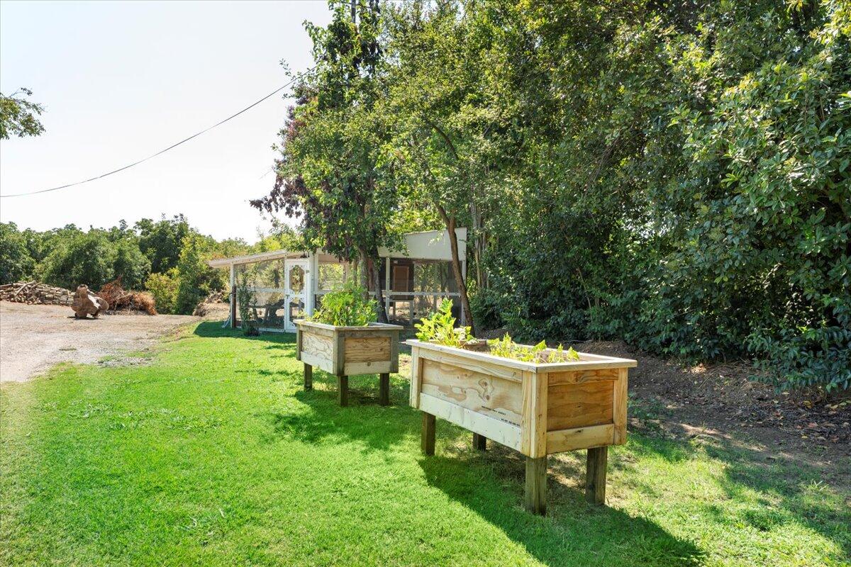 12325 Craig Avenue Red Bluff, CA 96080 - Photo 45 of 68 a view of a house with backyard sitting area and garden