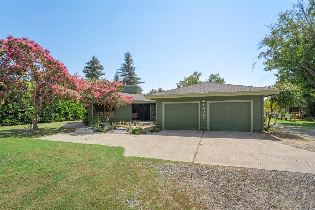 12325 Craig Avenue Red Bluff, CA 96080 - Photo 7 of 68 a view of a house with a yard and a garage