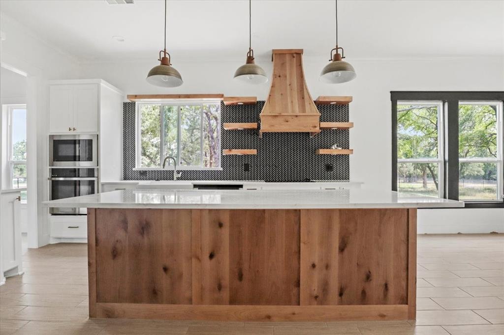 1791 JE Woody Road Springtown, TX 76082 - Photo 11 of 33 a living room with stainless steel appliances granite countertop furniture and a wooden floor