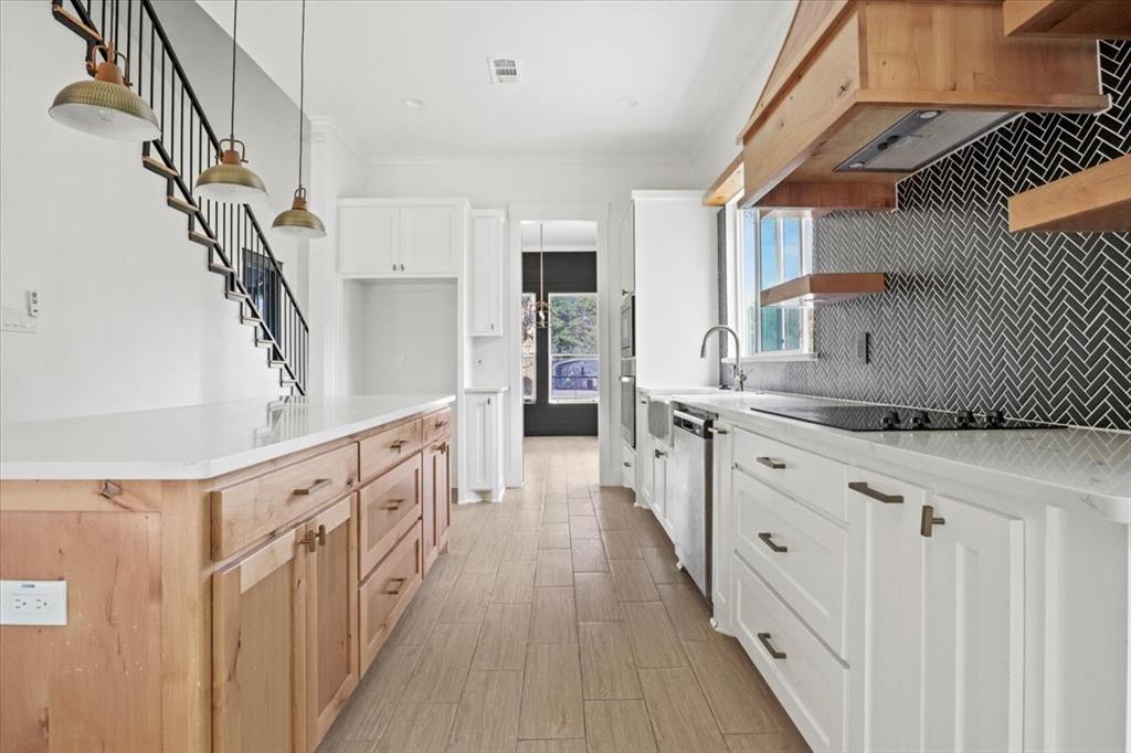 1791 JE Woody Road Springtown, TX 76082 - Photo 14 of 33 a kitchen with cabinets a sink and wooden floor