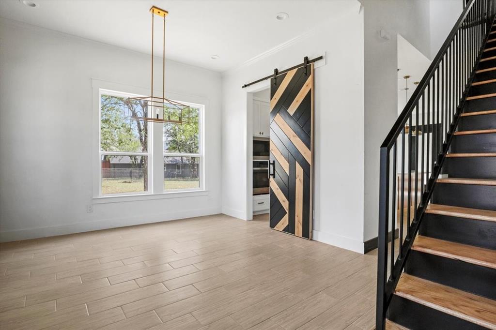 1791 JE Woody Road Springtown, TX 76082 - Photo 4 of 33 a view of empty room with wooden floor and fan