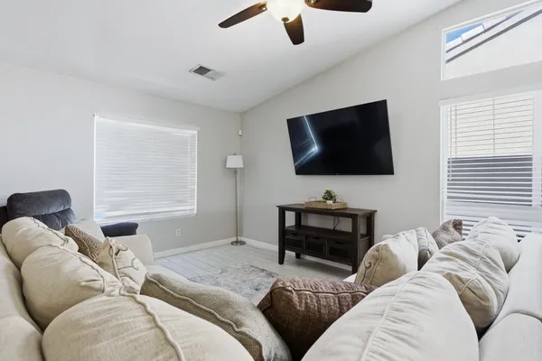 a kitchen with a sink stainless steel appliances and view living room