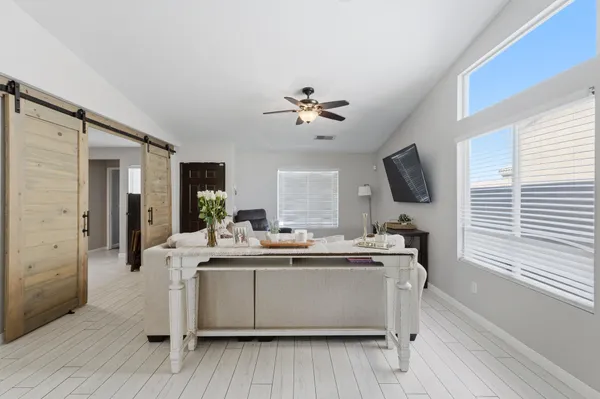 a bedroom with a bed and a large window