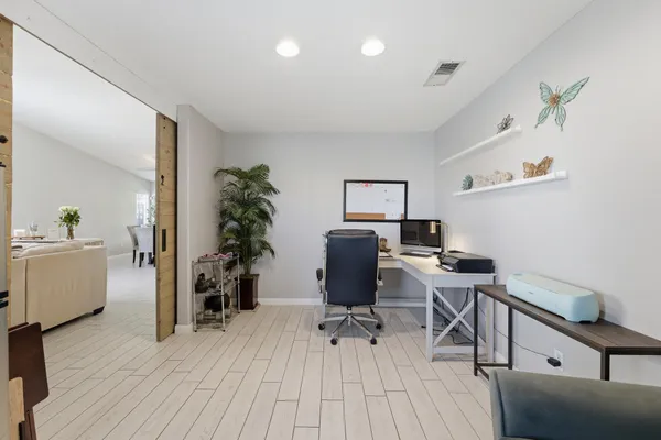 a bathroom with a granite countertop sink a mirror and shower