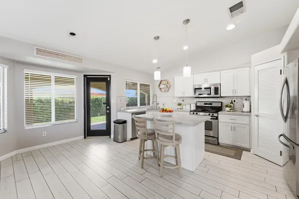 a view of yard with table and chairs and wooden floor