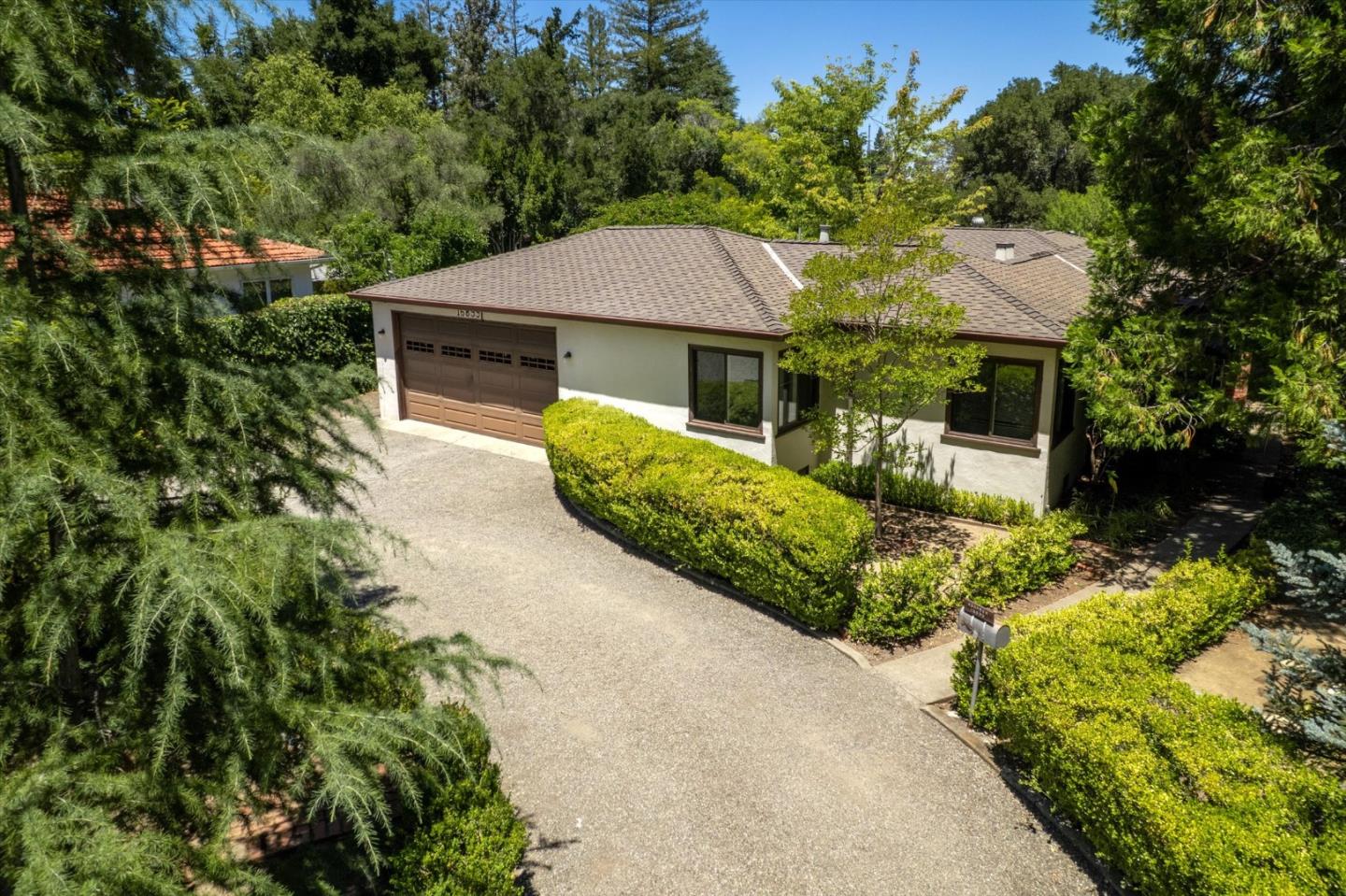 16899 Kennedy Road Los Gatos, CA 95032 - Photo 2 of 61 a front view of a house with a yard and garage