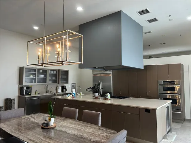 a kitchen with a sink and stainless steel appliances
