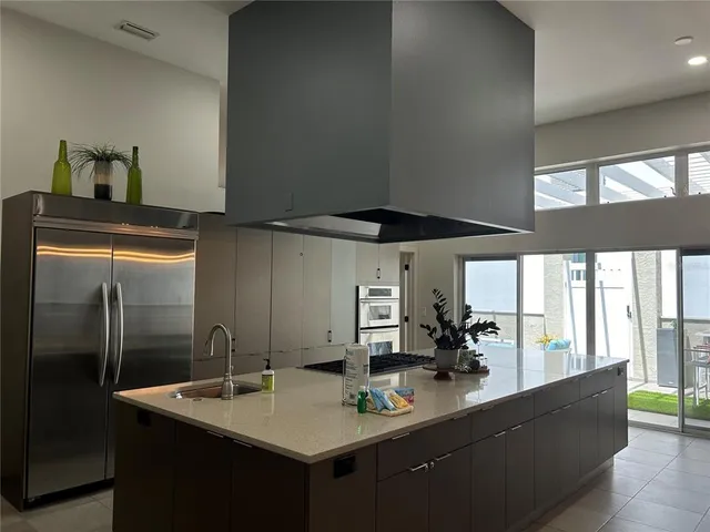 a kitchen with a stove a sink and a refrigerator
