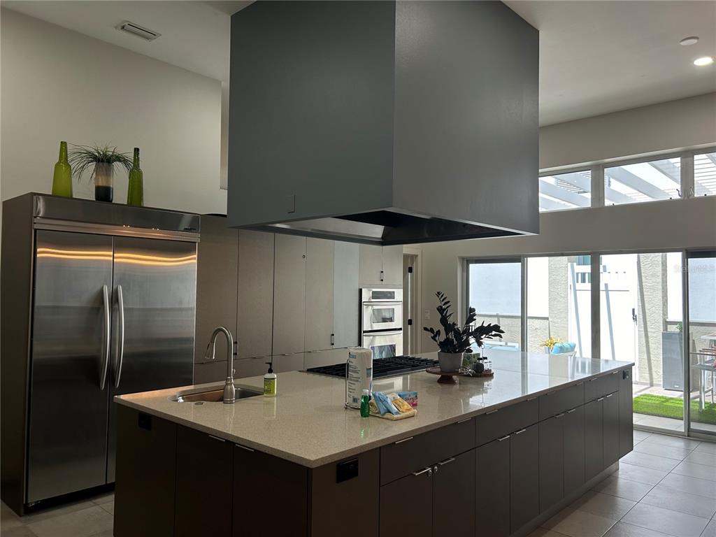 1345 2nd Street, Unit C Sarasota, FL 34236 - Photo 14 of 56 a kitchen with sink refrigerator and window
