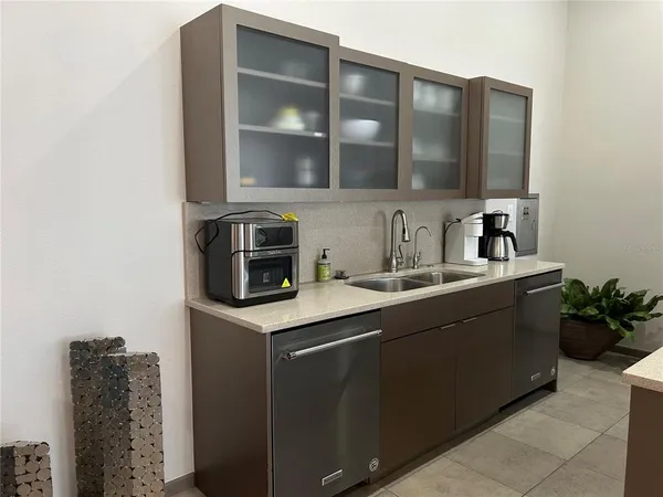 a living room with furniture a fireplace and a chandelier