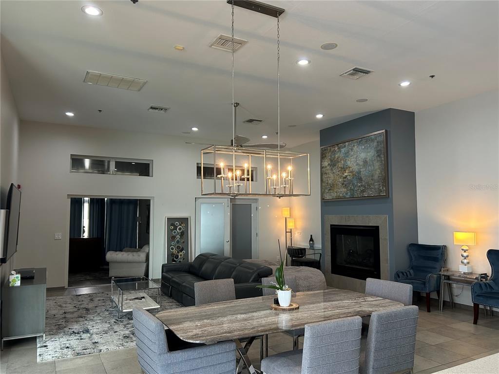 1345 2nd Street, Unit C Sarasota, FL 34236 - Photo 22 of 56 a living room with furniture a fireplace and a chandelier