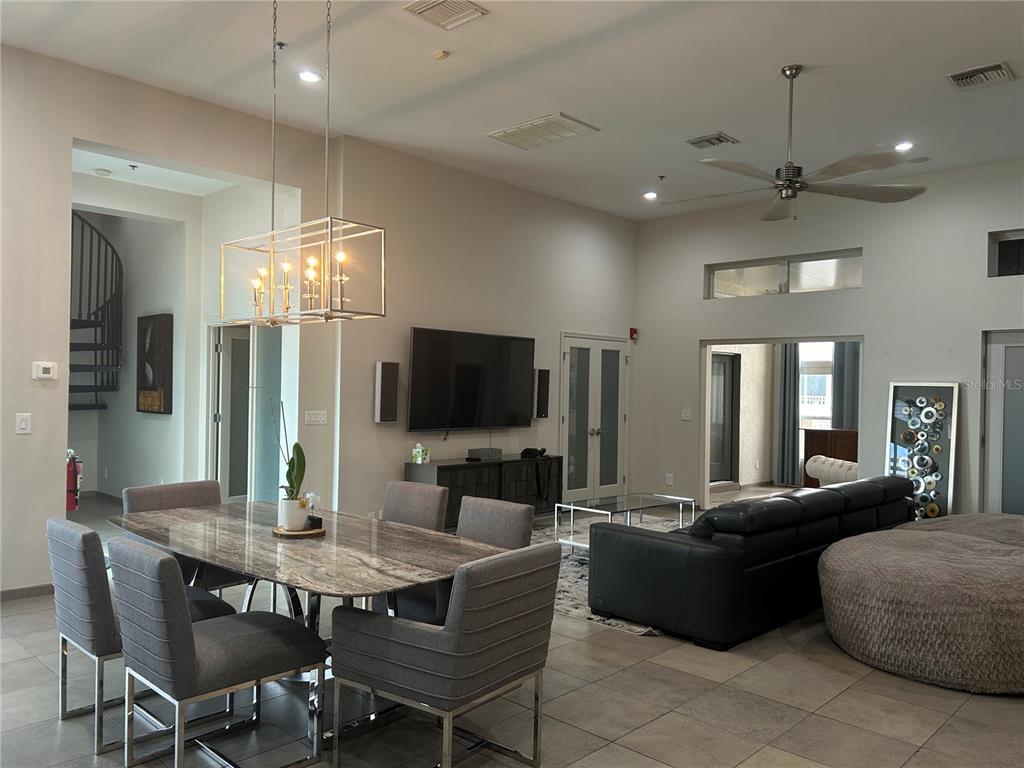 1345 2nd Street, Unit C Sarasota, FL 34236 - Photo 24 of 56 a living room with furniture a flat screen tv and kitchen view