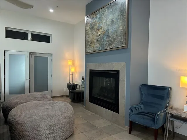 a living room with furniture a fireplace and a flat screen tv