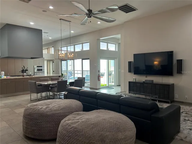 a bedroom with a large bed and a flat tv screen