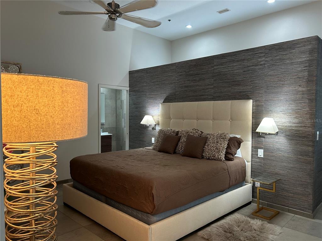 1345 2nd Street, Unit C Sarasota, FL 34236 - Photo 30 of 56 a bedroom with a bed and a chandelier