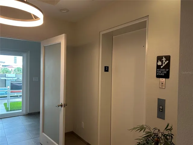a view of a hallway to a livingroom with furniture