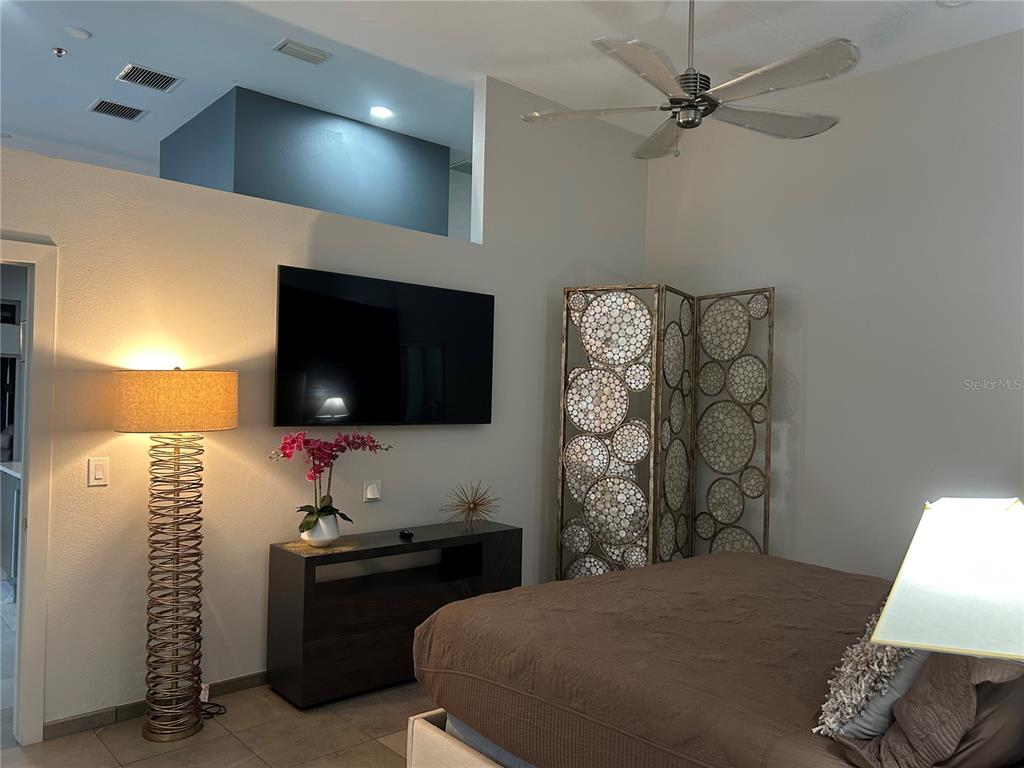 1345 2nd Street, Unit C Sarasota, FL 34236 - Photo 31 of 56 a bedroom with a bed and a flat screen tv