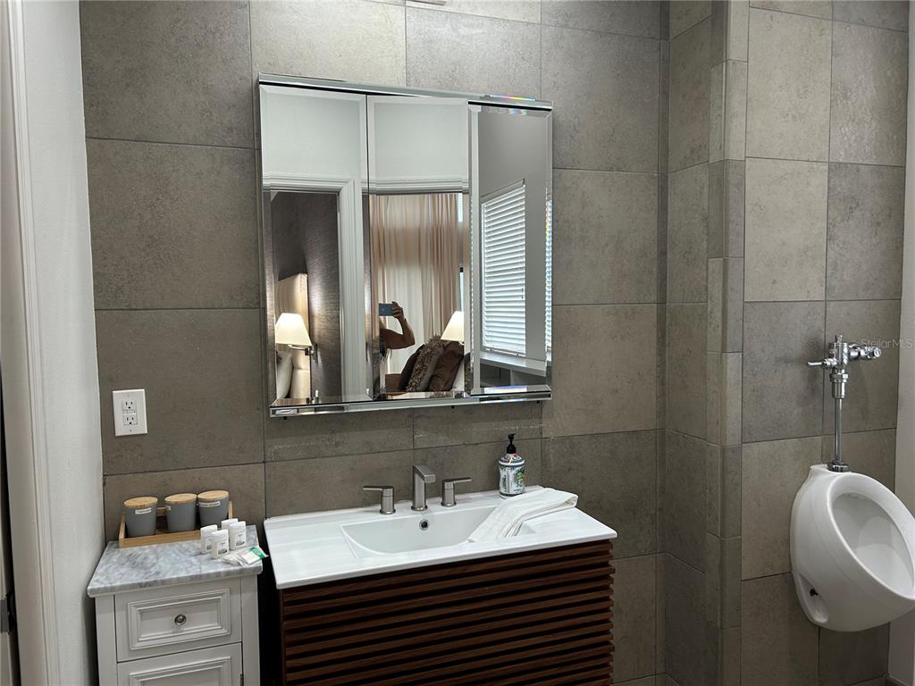 1345 2nd Street, Unit C Sarasota, FL 34236 - Photo 34 of 56 a bathroom with a sink and a mirror