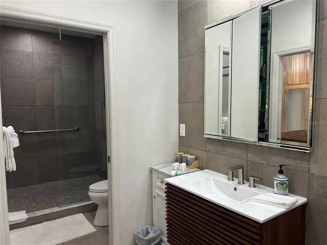 a bedroom with a bed and painting on the wall