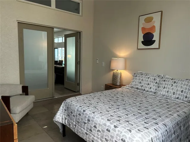 a bedroom with a bed and a dresser