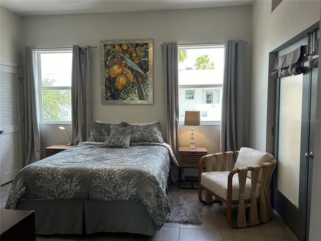a bedroom with furniture and a window