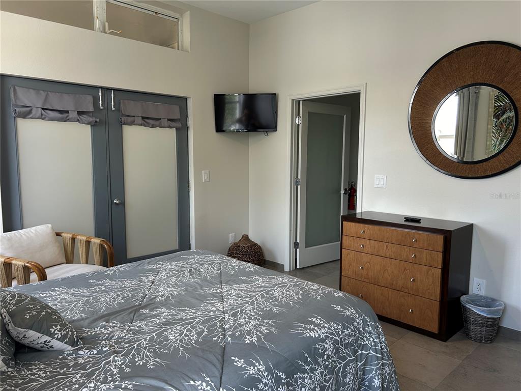 1345 2nd Street, Unit C Sarasota, FL 34236 - Photo 43 of 56 a bedroom with a bed and a dresser