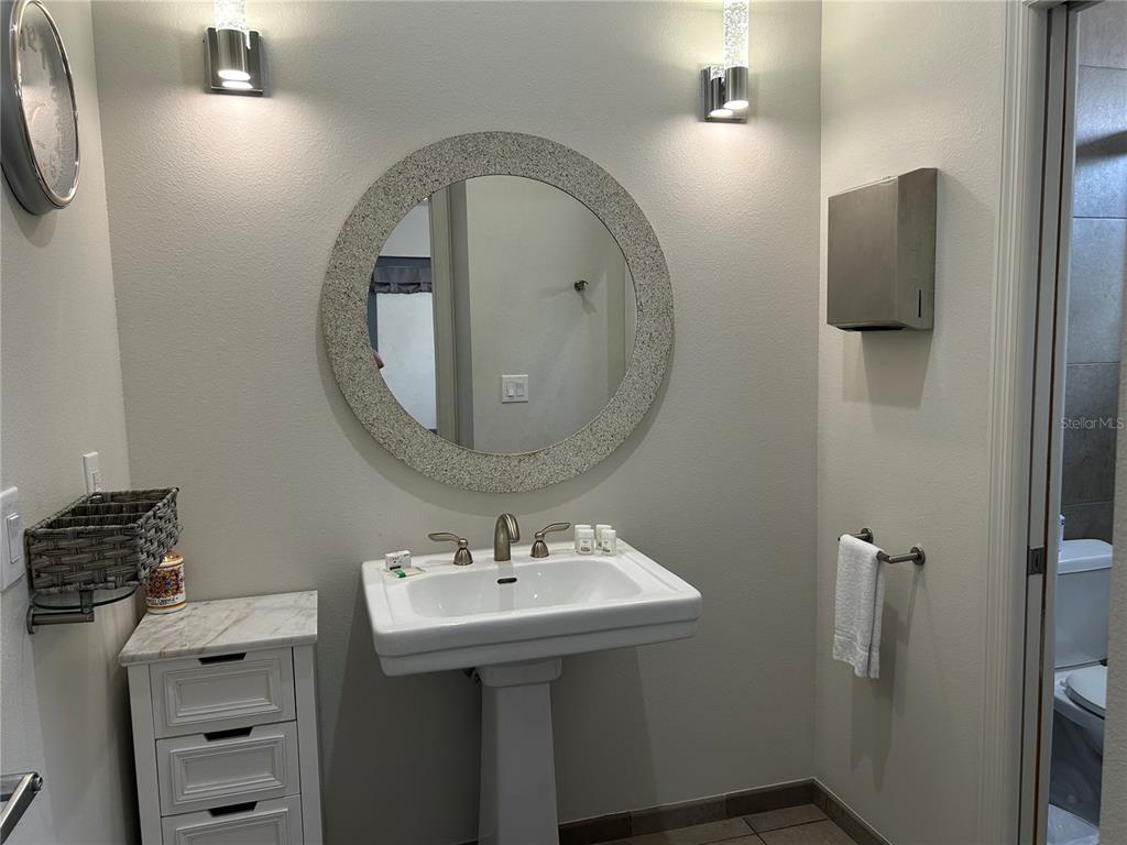 1345 2nd Street, Unit C Sarasota, FL 34236 - Photo 44 of 56 a bathroom with a sink and mirror