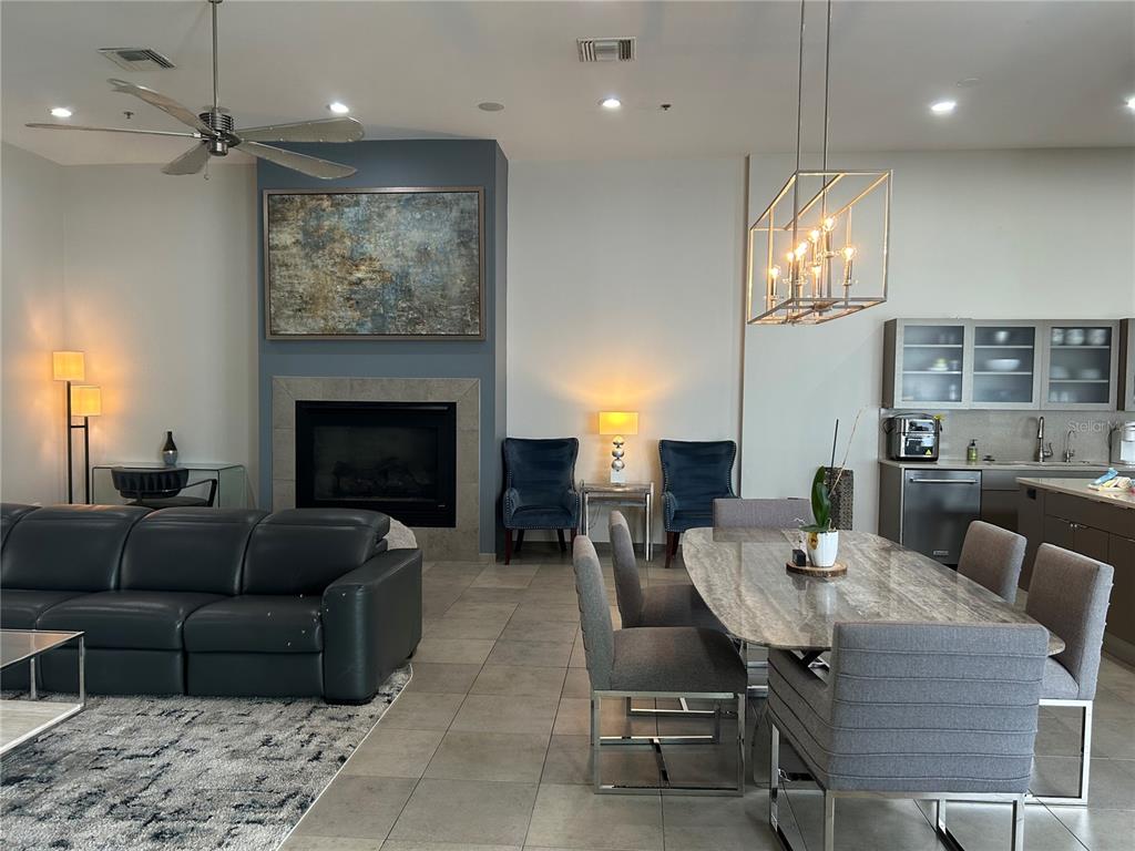 1345 2nd Street, Unit C Sarasota, FL 34236 - Photo 6 of 56 a living room with furniture a fireplace and a chandelier