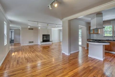 a view of a kitchen cabinets and wooden floor