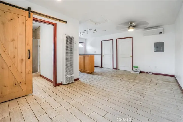 a view of a room with wooden floor and cabinet