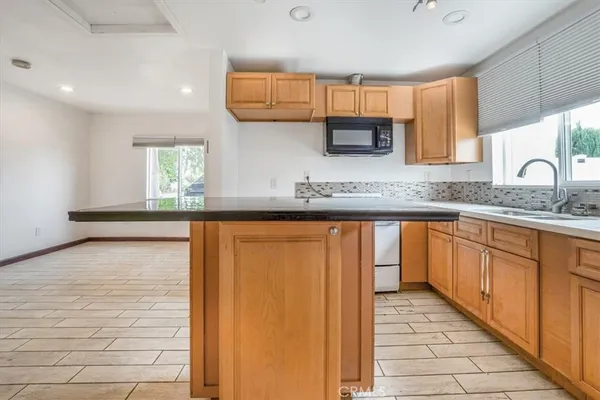 a kitchen with stainless steel appliances granite countertop a sink and a stove top oven