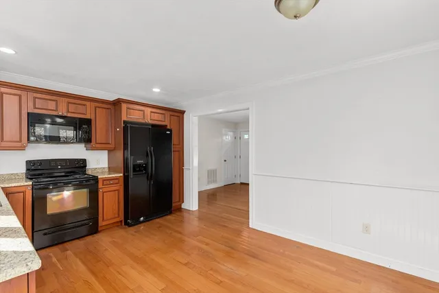 a kitchen with granite countertop a refrigerator stove and oven