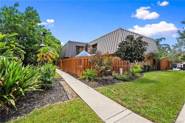 a view of a house with a yard and plant