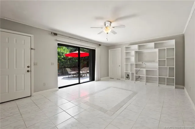 a view of an empty room with a window and a flat screen tv