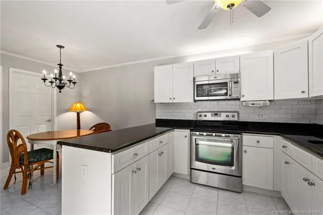 a kitchen with a stove cabinets and window