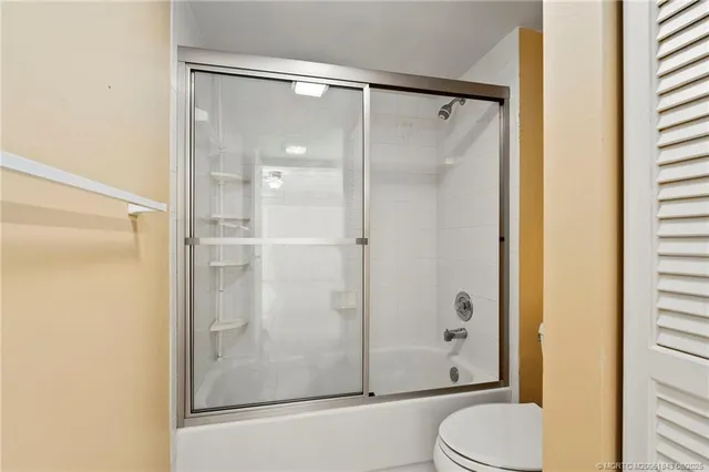 a bathroom with a shower and toilet