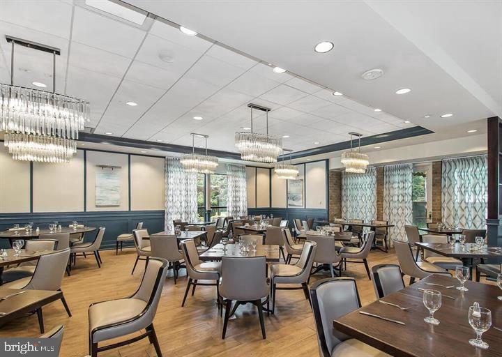 3200 North Leisure World Boulevard, Unit 203 Silver Spring, MD 20906 - Photo 21 of 32 a room with lots of chairs and a potted plant