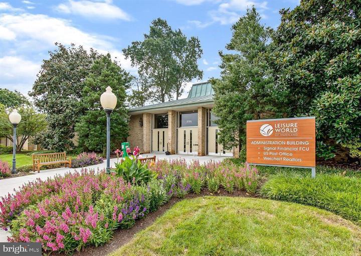 3200 North Leisure World Boulevard, Unit 203 Silver Spring, MD 20906 - Photo 24 of 32 a front view of a house with a yard and potted plants