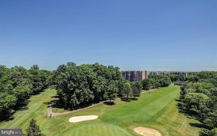 3200 North Leisure World Boulevard, Unit 203 Silver Spring, MD 20906 - Photo 30 of 32 a view of a garden with a building in the background