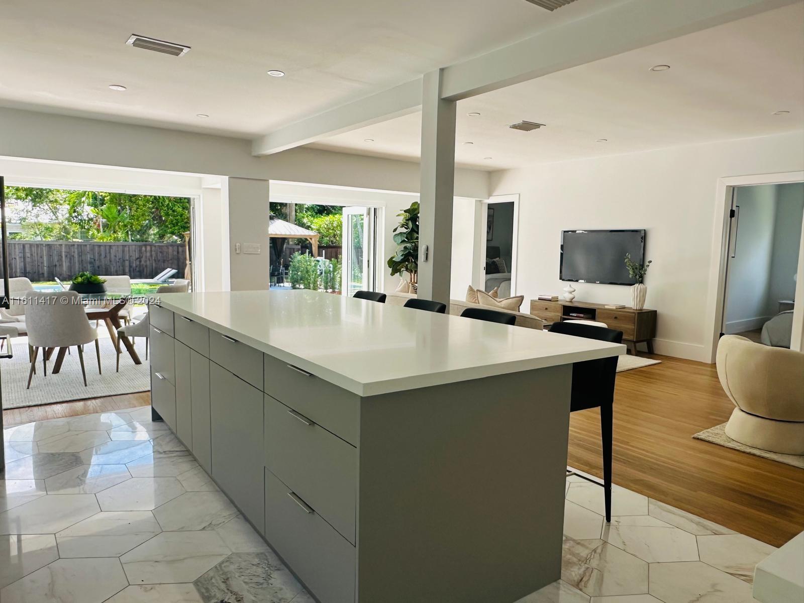 801 Southwest 27th Road Miami, FL 33129 - Photo 8 of 23 a kitchen with a sink and living room view