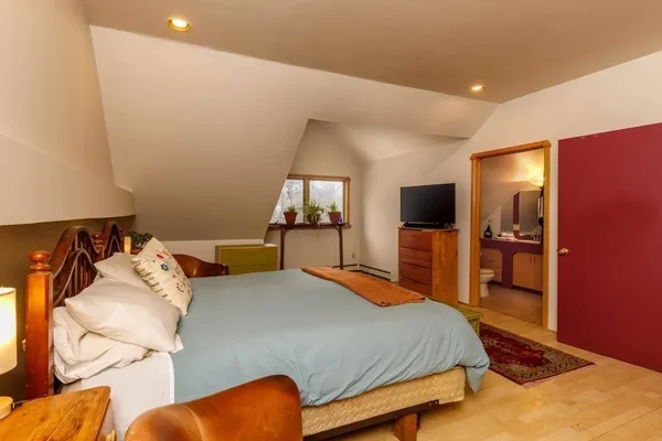 a bedroom with a bed and a flat screen tv