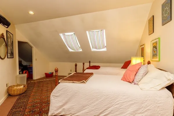 a bedroom with a bed and a large mirror