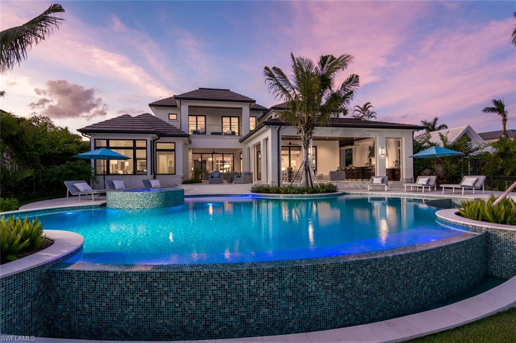 a view of a house with swimming pool yard and a porch