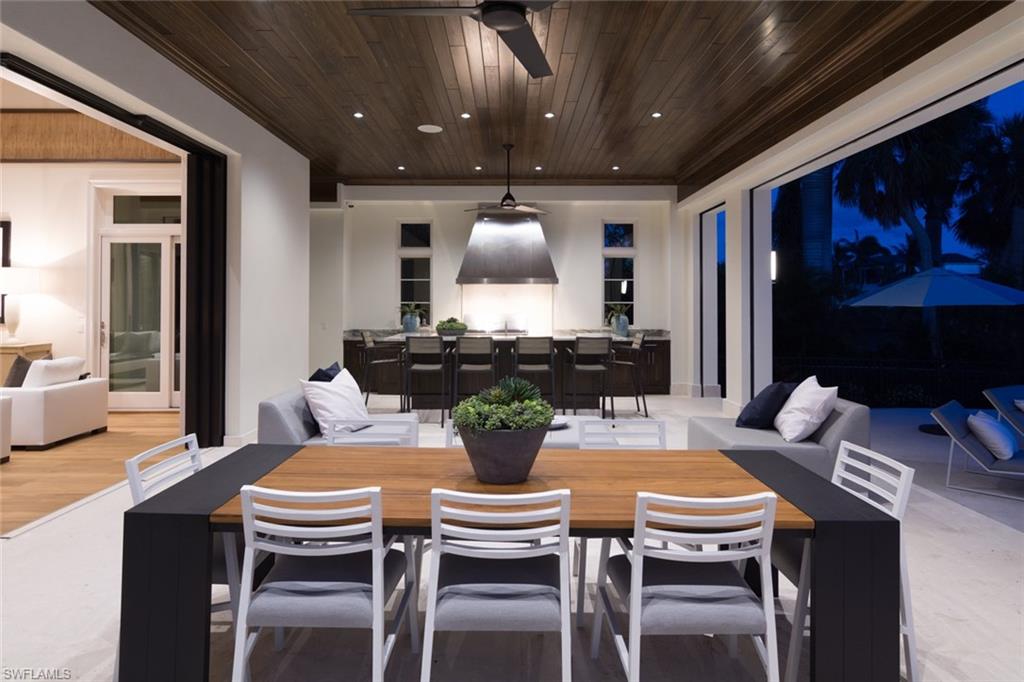 870 Nelson`s Walk Naples, FL 34102 - Photo 15 of 24 a kitchen with a dining table and chairs