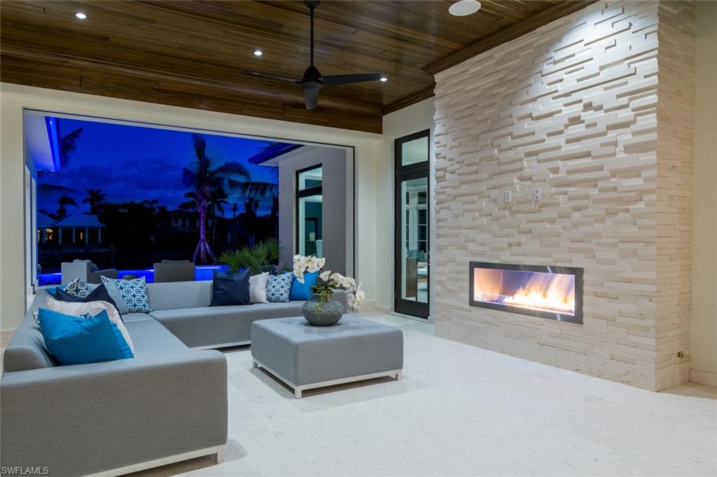 870 Nelson`s Walk Naples, FL 34102 - Photo 16 of 24 a living room with furniture and a fireplace