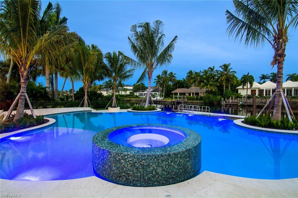 870 Nelson`s Walk Naples, FL 34102 - Photo 21 of 24 a view of a swimming pool with a table and chairs