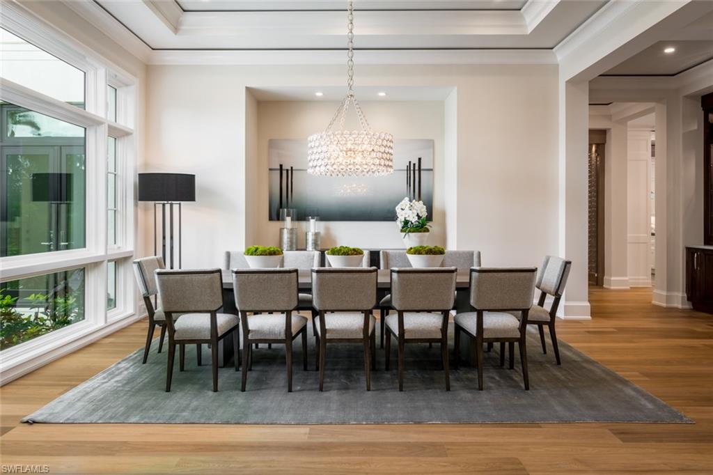 870 Nelson`s Walk Naples, FL 34102 - Photo 4 of 24 a dining room with furniture a chandelier and wooden floor
