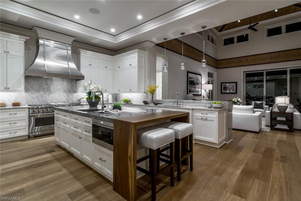 870 Nelson`s Walk Naples, FL 34102 - Photo 8 of 24 a kitchen with a sink stainless steel appliances and cabinets